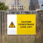 Caution Pedestrians Look Left Sign
