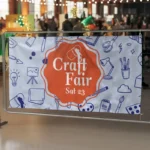Shaadi Wedding Banners: Printed craft fair banner on railings at a market
